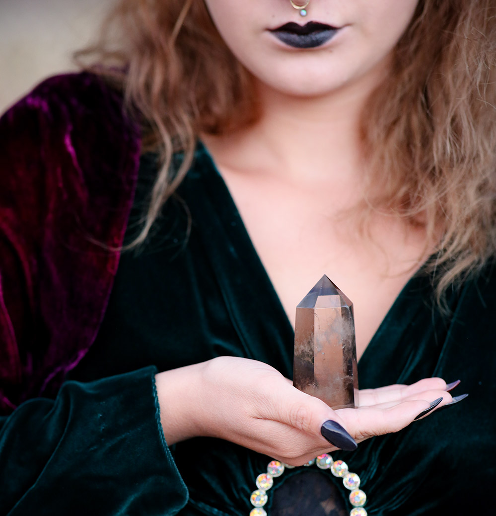 woman holding smoky quartz crystal